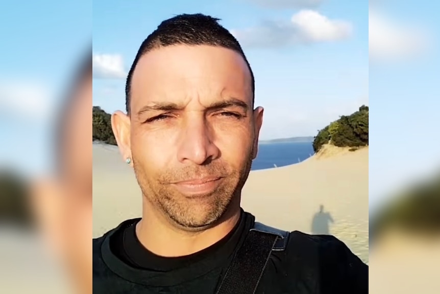 A selfie of a man at a beach