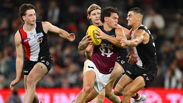 Cam Rayner of the Lions clears the ball from the centre.