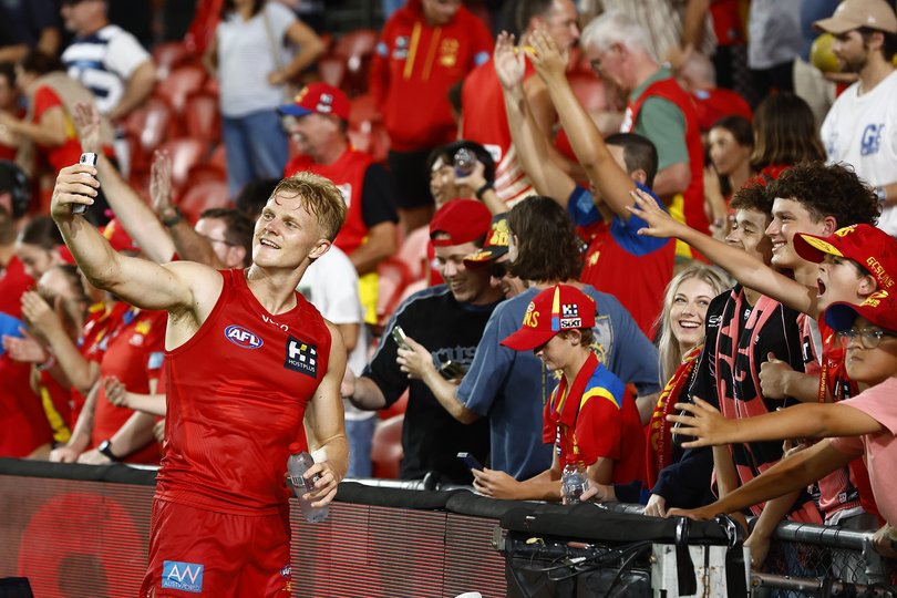 Bodhi Uwland of the Suns interacts with fans following the 2026 AFL Opening Round match.