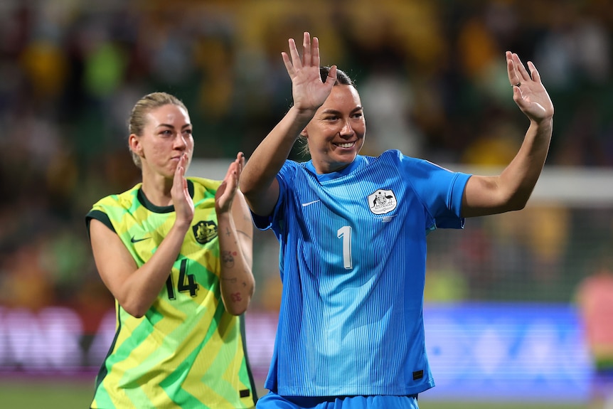 Mackenzie Arnold and Alanna Kennedy both wave to the crowd
