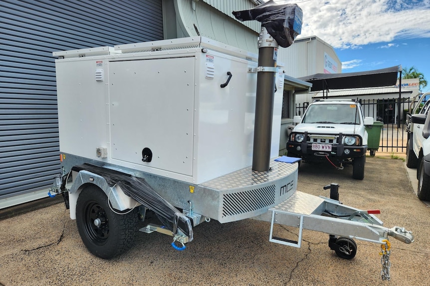 A trailer in a yard.