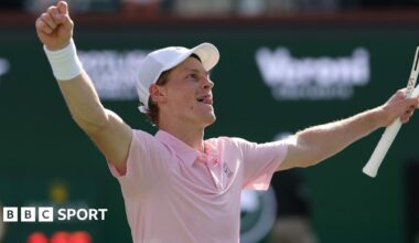 Jannik Sinner raises his arms in celebration after winning the Indian Wells title