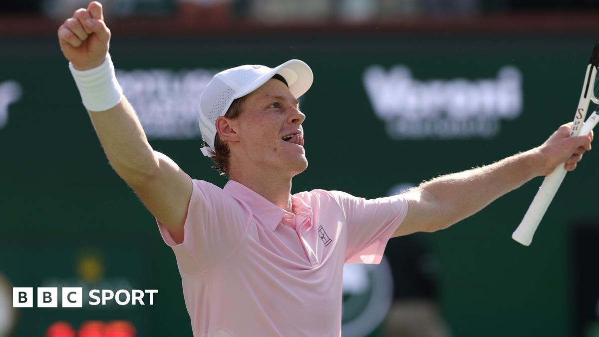 Jannik Sinner raises his arms in celebration after winning the Indian Wells title