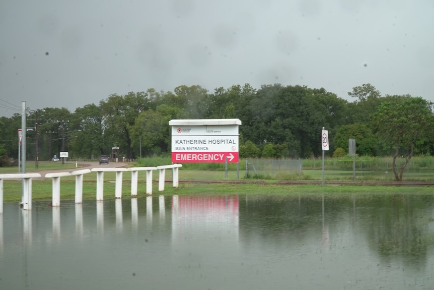 A hospital sign, with high water levels all around it.