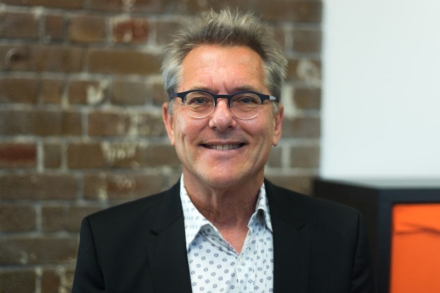 Peter Leonard smiles at the camera 