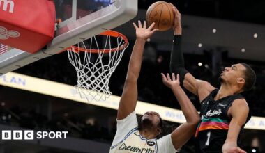 Victor Wembanyama of the San Antonio Spurs shoots the ball against Myles Turner of the Milwaukee Bucks