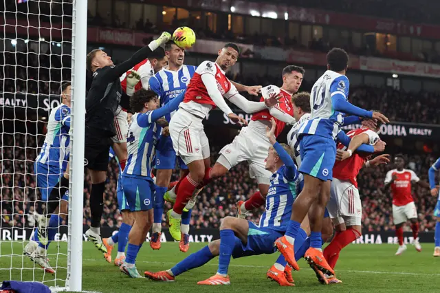 : Lewis Dunk of Brighton & Hove Albion heads the ball away from an Arsenal corner kick
