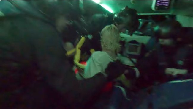 Jacob Tait (16) inside the rescue helicopter on a stretcher after being winched from the gorge during the dramatic rescue.