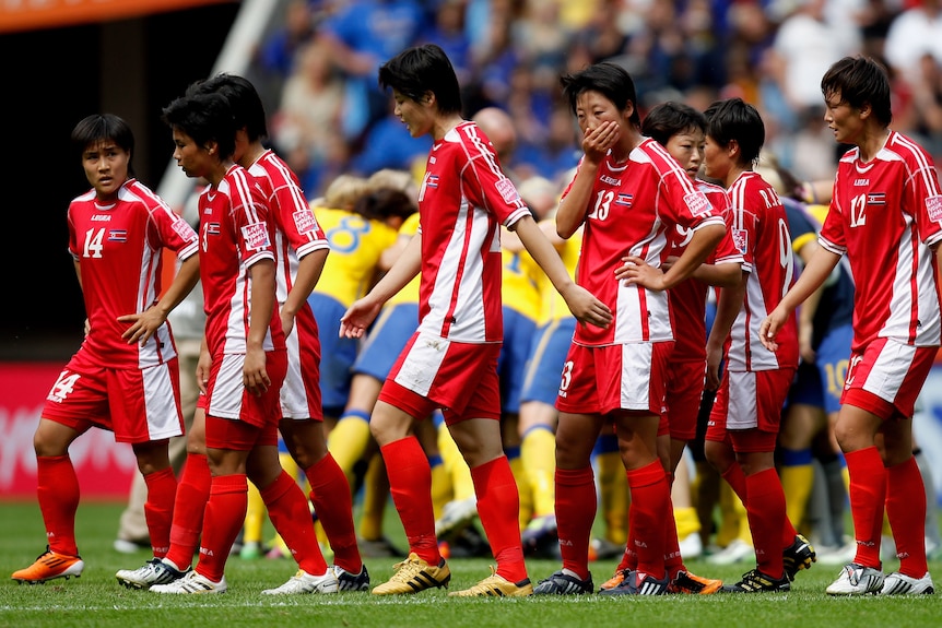 The North Korean players take a break from the action