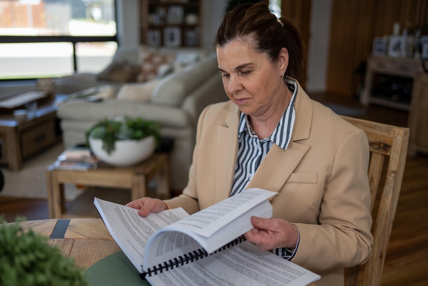 A woman flicking through an early version of a book she had written. 
