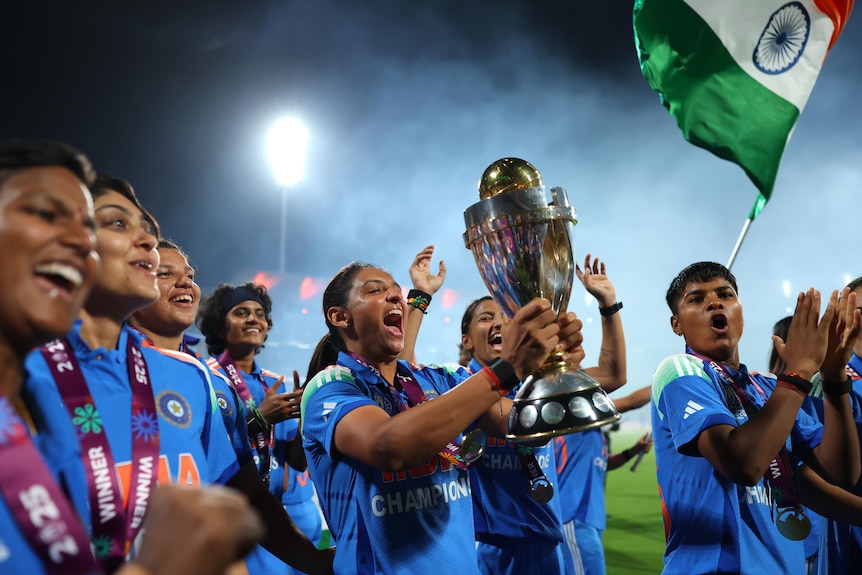Harmanpreet Kaur celebrates with the World Cup trophy
