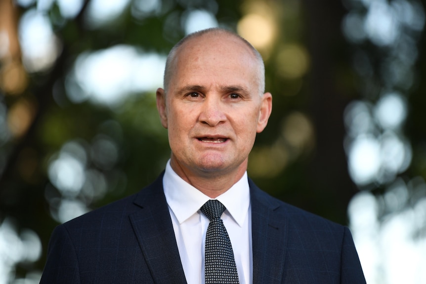 a head-and-shoulders profile image of state mp glenn butcher giving an outdoor press conference