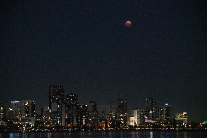 A wide shot of orangeish moon when lunar eclipse is happening in Perth. 