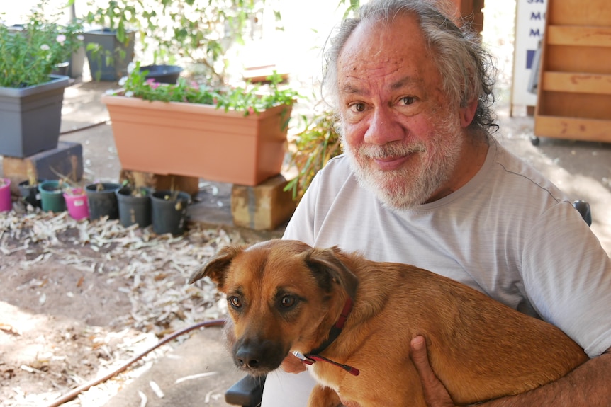 Derby resident Victor Patrick pictured at home with his dog.