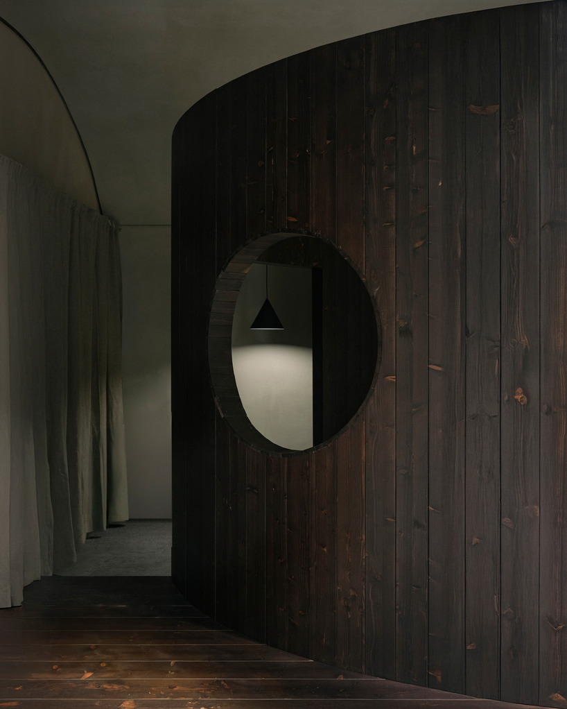 perforated wooden screens filter light and shadow within milan ceramic workshop - 3