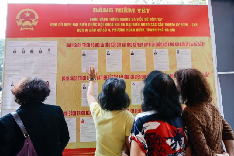 epa12820474 People look at the lists of candidates at a polling station in Hanoi, Vietnam 15 March 2026. Vietnam holds general elections for the 16th National Assembly and People's Councils at all levels for the 2026–2031 term on 15 March. EPA/LUONG THAI LINH