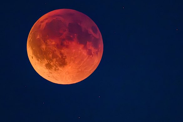 The moon appears red in a total lunar eclipse, known as the blood moon.
