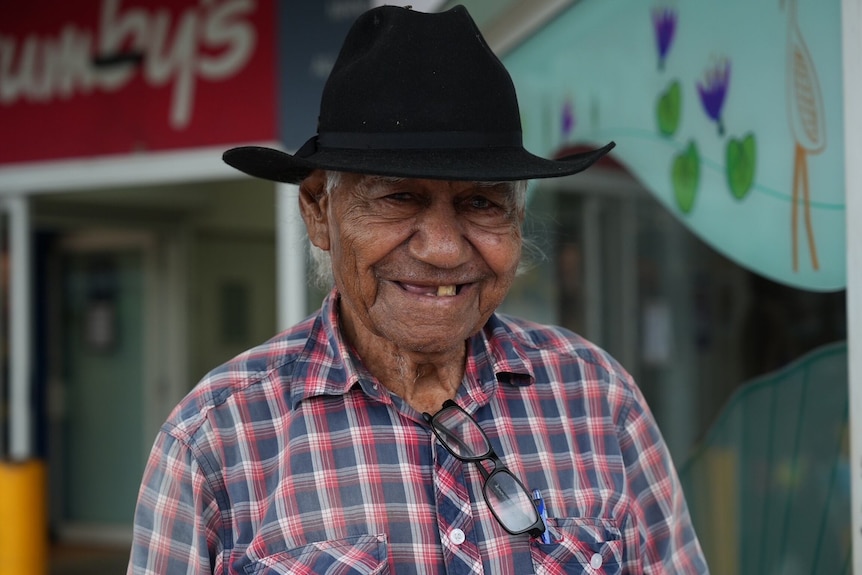 Man with black hat smiles 