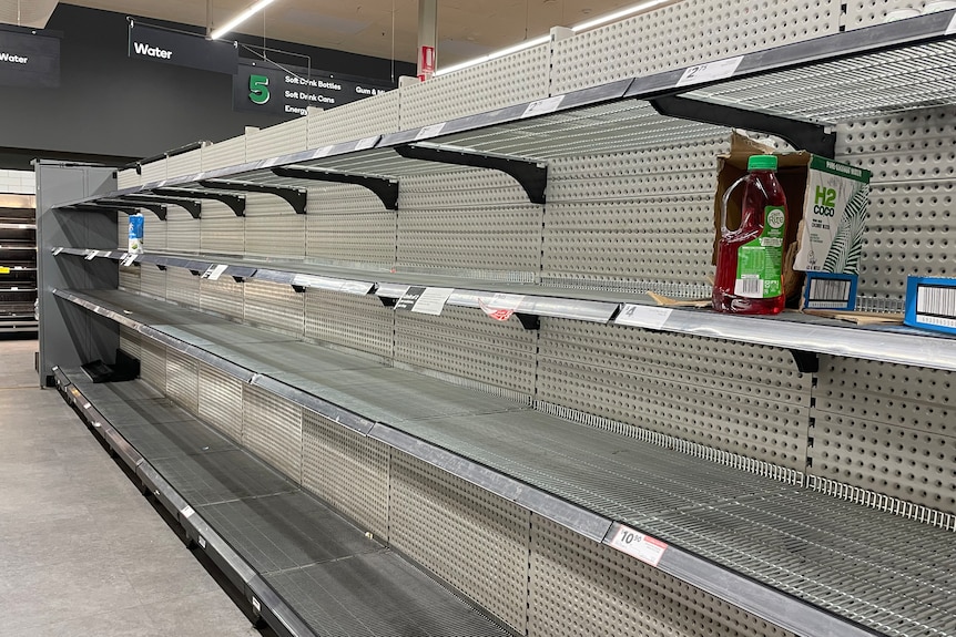 Completely empty supermarket shelves where bottle water would be