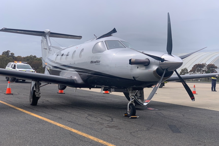 Single engined propeller plane on an air tarmac.