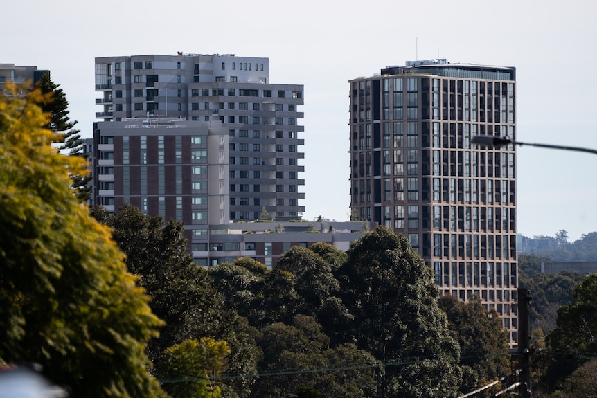 Black sign on a beige wall