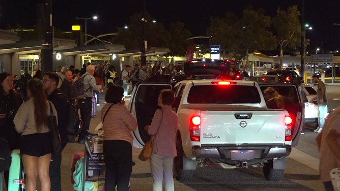 Crowds were seen outside Perth Airport on Sunday night after services to Doha and Dubai were impacted