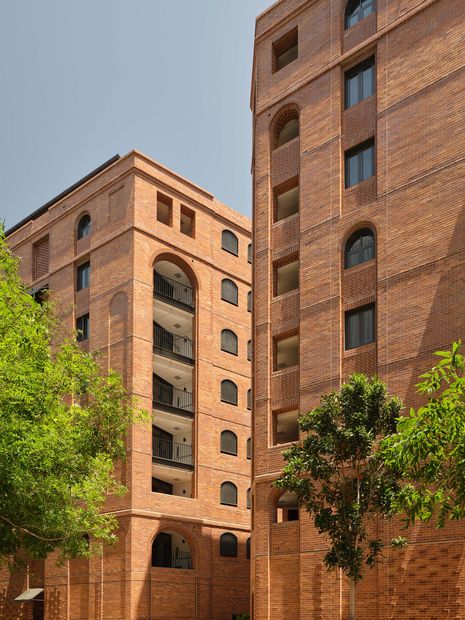 JPW’s design includes two eight-storey CLT apartment buildings, whose red-brick cladding and metal-framed windows nod to the language of nearby woolstore buildings.
