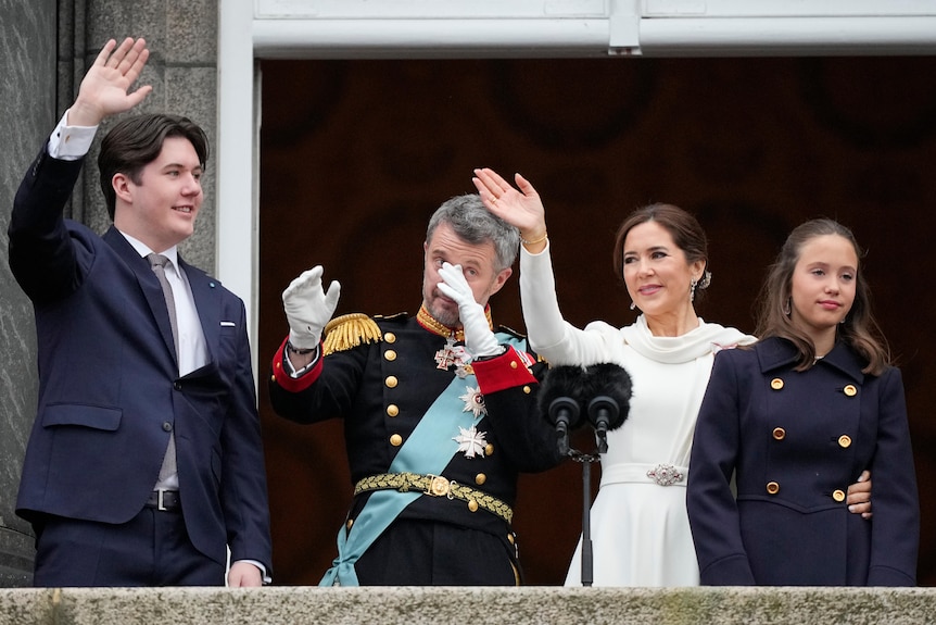A man crying while his family stands next to him