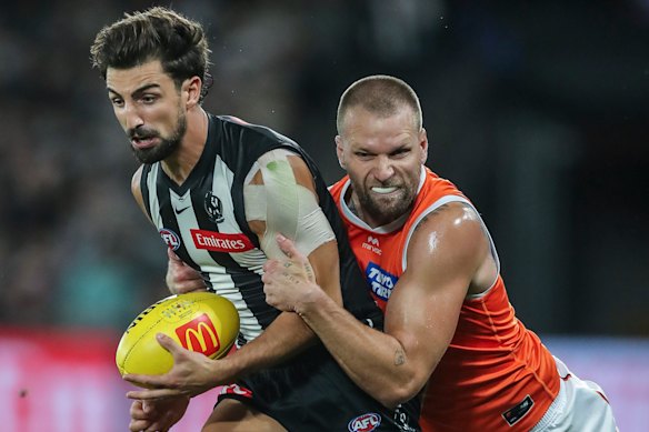 Jake Stringer of the Giants wins a free kick for holding the ball for this tackle on Josh Daicos of the Magpies.