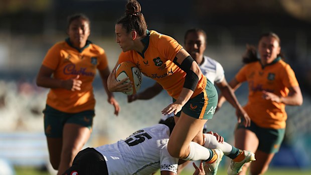 Maya Stewart of the Wallaroos is tackled.