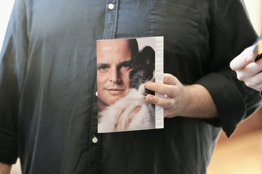 A man holds the order of service at the funeral of Maxi Shields.