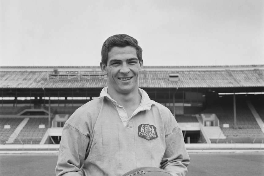 Ken Irvine poses with a football during a training session