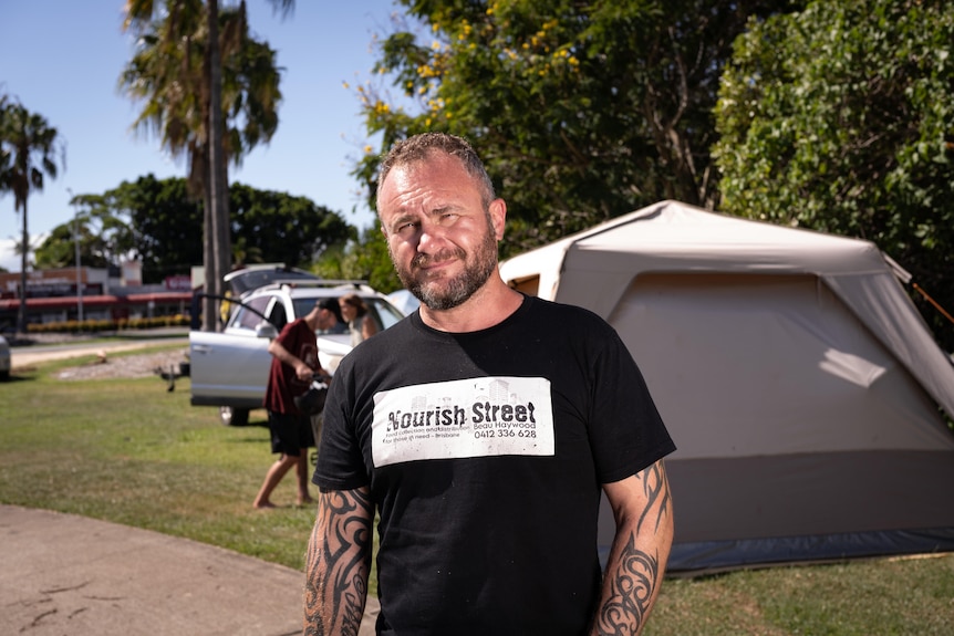 A man next to a tent