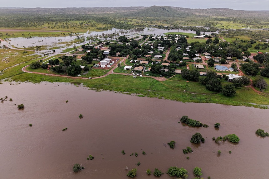 Drone image of small town with flood waters around it