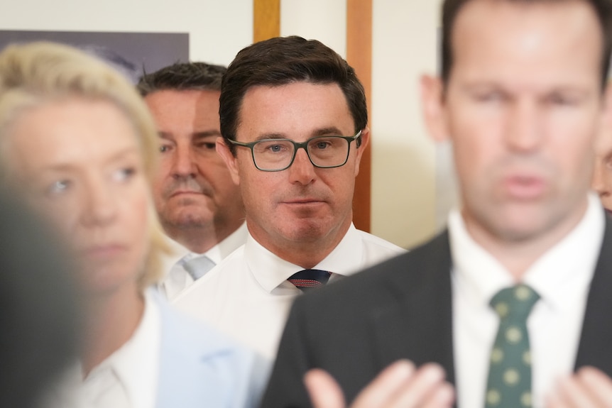 A roomful of people in formal attire.