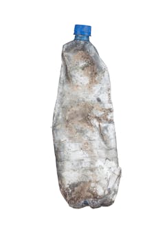 dirty empty plastic bottle on white background