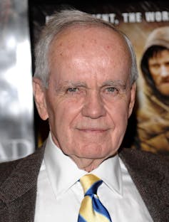 Another baldy old white man, this time in a suit and tie.