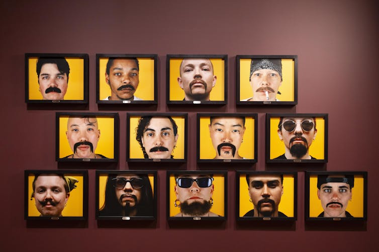 photos of faces on a wall