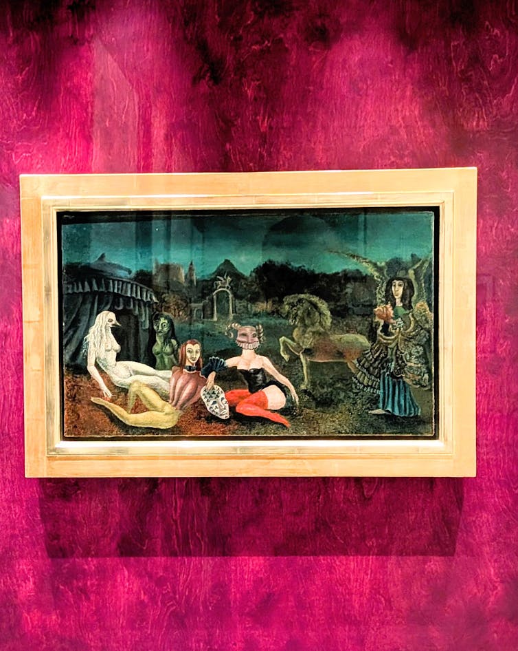 A surreal painting hanging on a plush red wall.