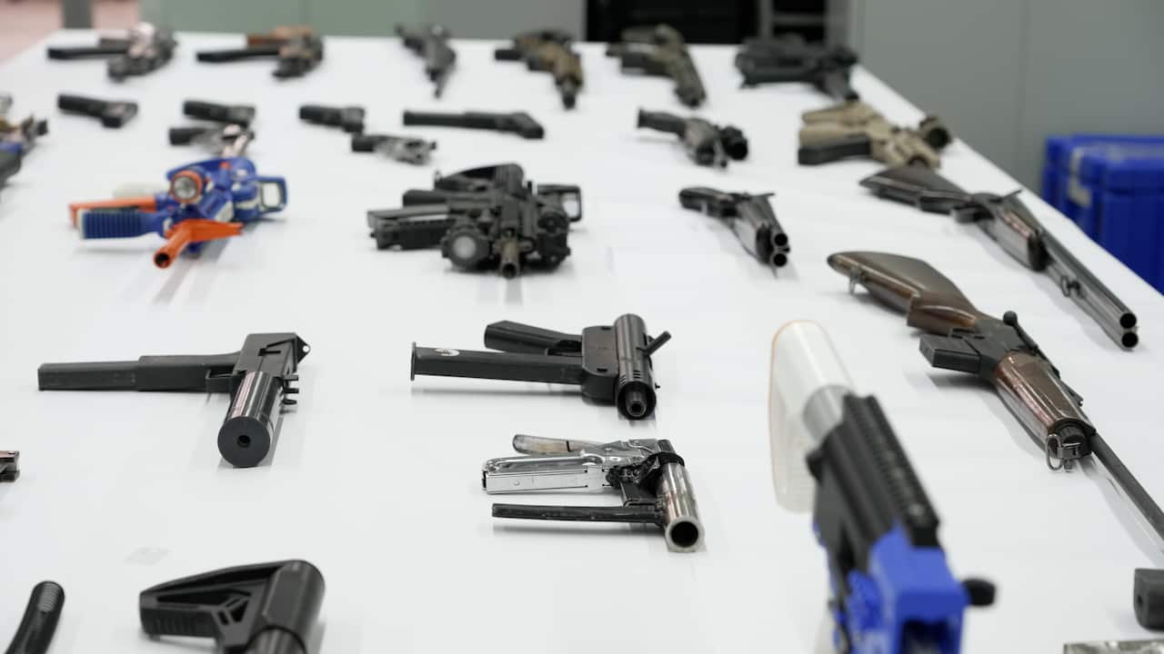 A table filled with homemade guns. 