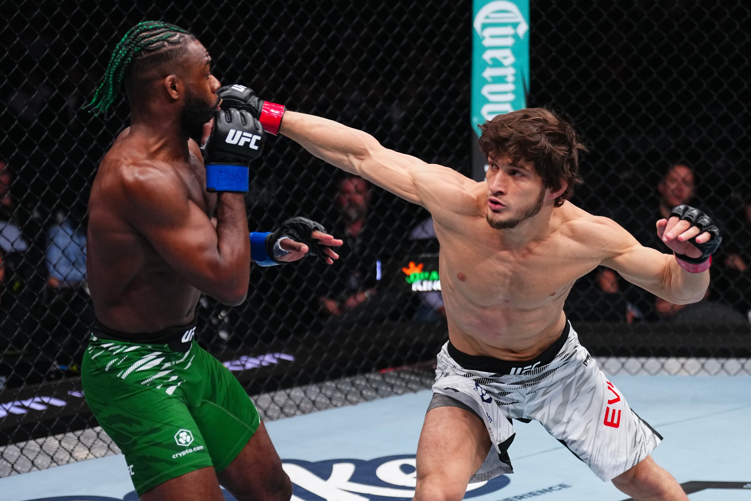 LAS VEGAS, NEVADA - DECEMBER 07: Movsar Evloev of Russia punches Aljamain Sterling in a featherweight bout during the UFC 310 event at T-Mobile Arena on December 07, 2024 in Las Vegas, Nevada. (Photo by Jeff Bottari/Zuffa LLC)