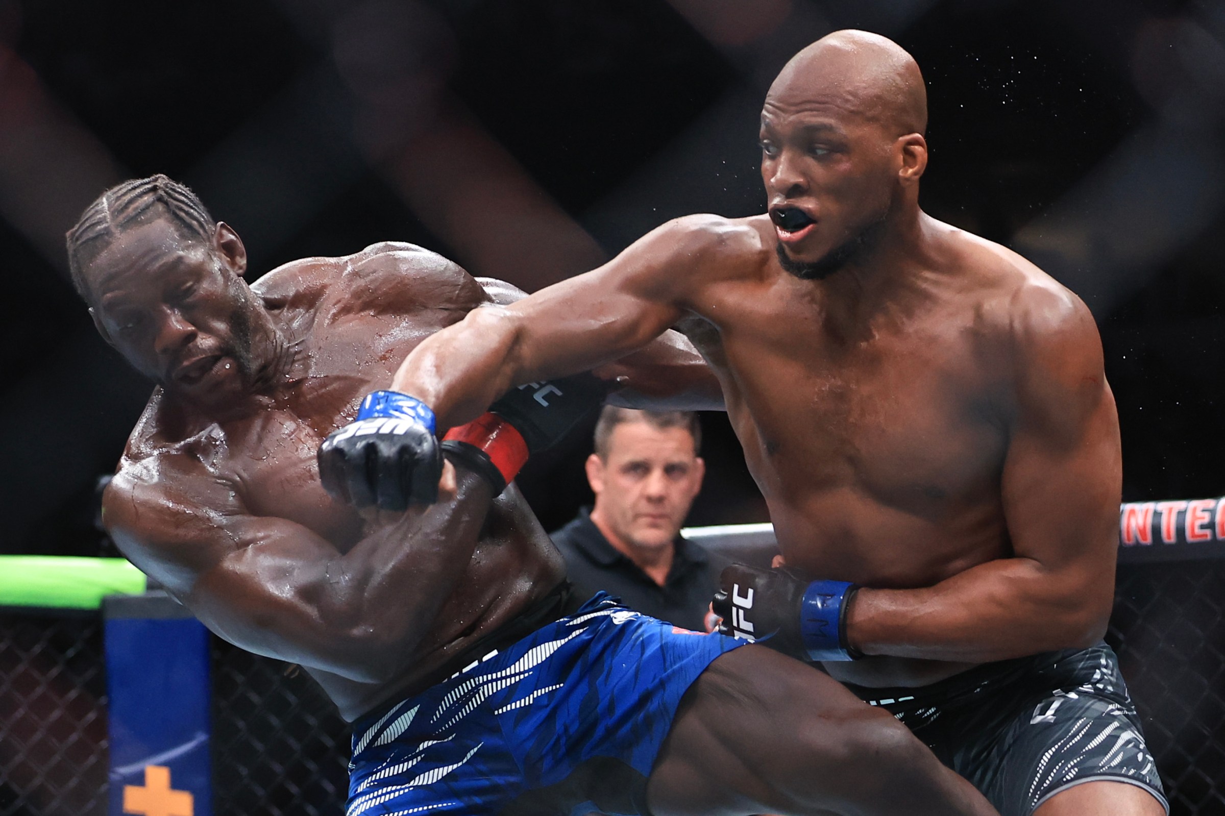 CHICAGO, ILLINOIS - AUGUST 16: Michael Page of England, right, strikes Jared Cannonier of the United States during their middleweight bout during UFC 319 at the United Center on August 16, 2025 in Chicago, Illinois. (Photo by Geoff Stellfox/Getty Images)
