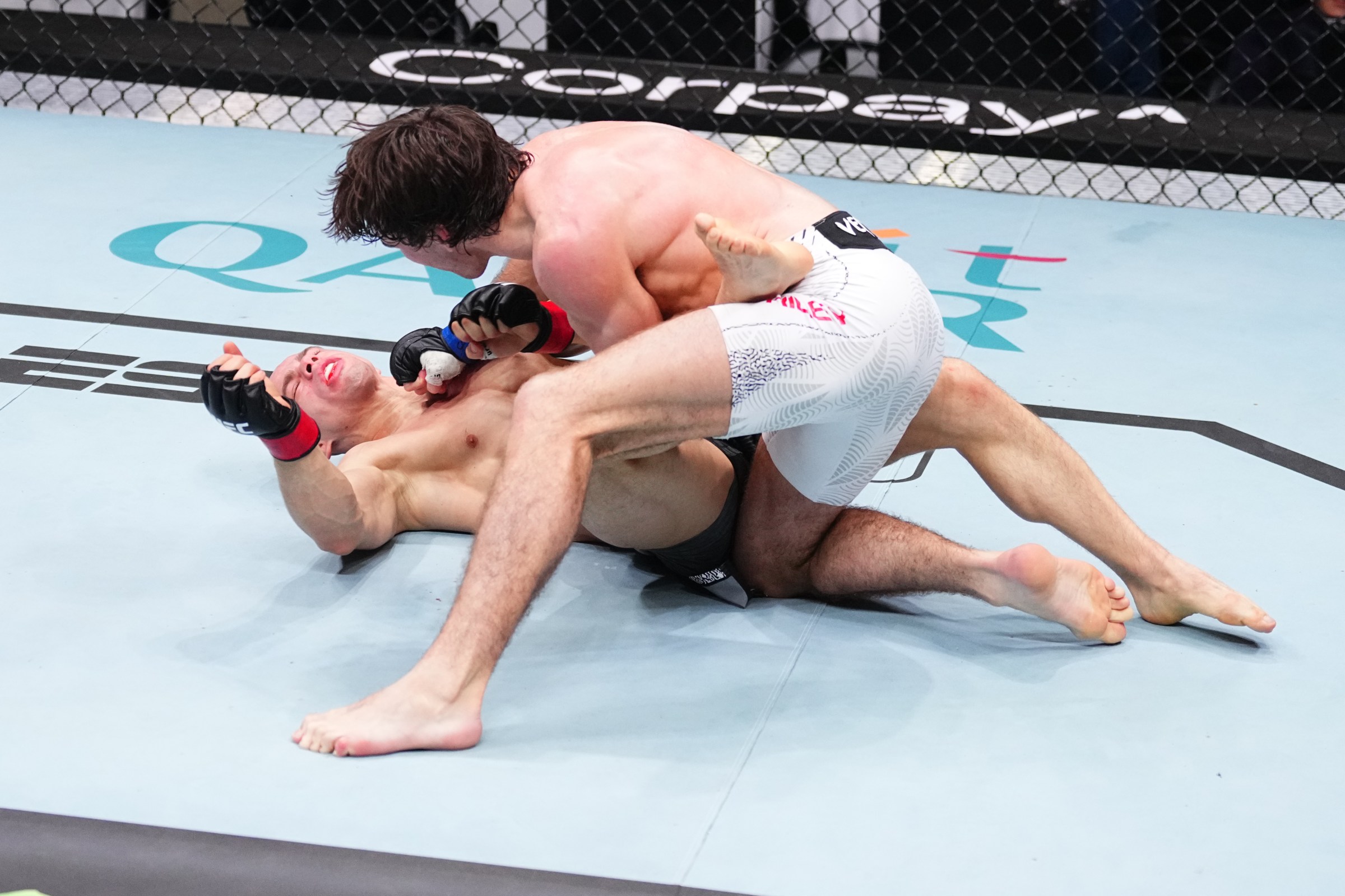 DOHA, QATAR - NOVEMBER 22: (R-L) Luke Riley of England punches Bogdan Grad of Romania in a featherweight fight during the UFC Fight Night event at ABHA Arena on November 22, 2025 in Doha, Qatar. (Photo by Jeff Bottari/Zuffa LLC)