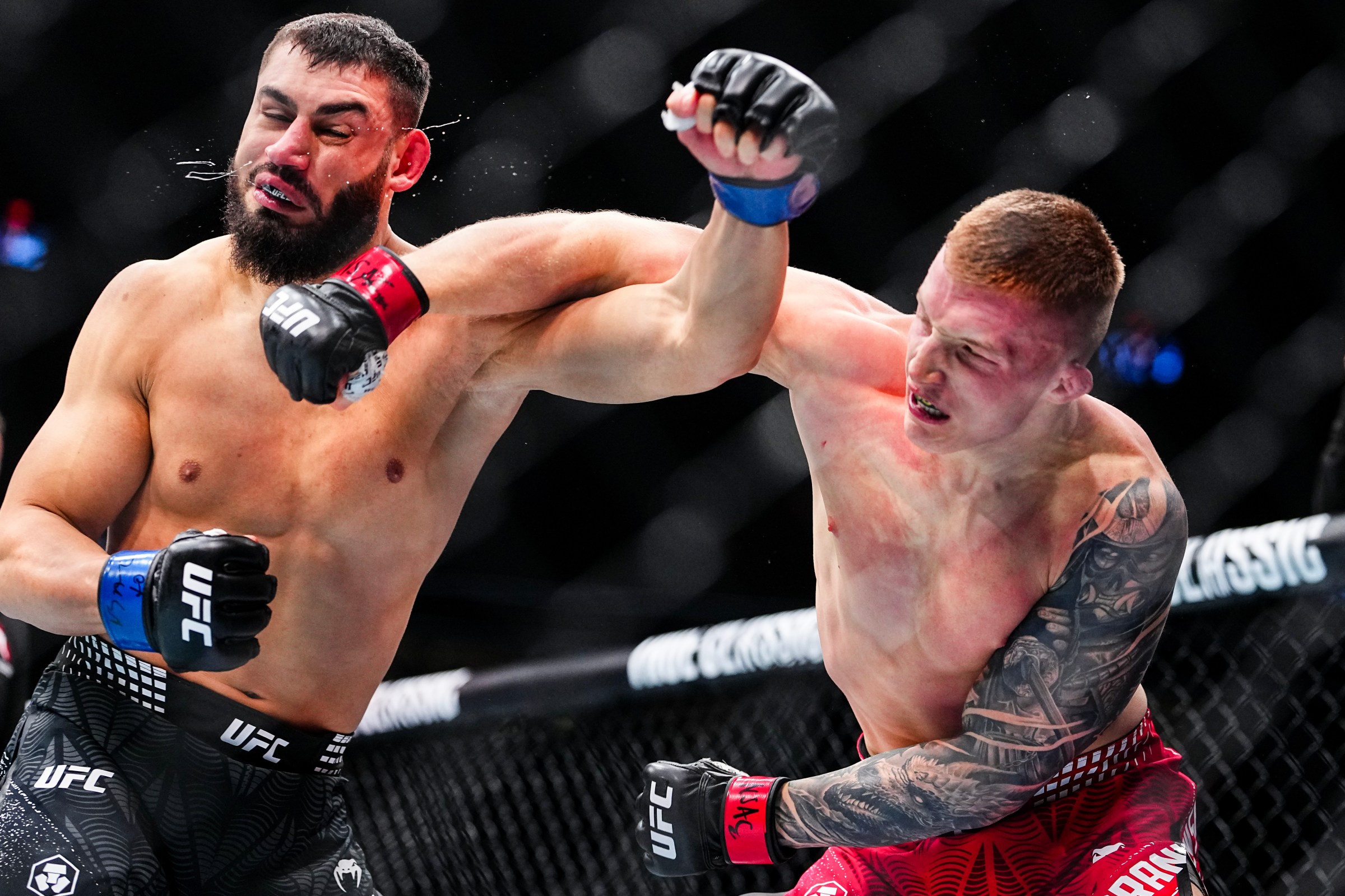 LAS VEGAS, NEVADA - DECEMBER 06: (R-L) Iwo Baraniewski of Poland punches Ibo Aslan of Turkey in a light heavyweight fight during the UFC 323 event at T-Mobile Arena on December 06, 2025 in Las Vegas, Nevada. (Photo by Chris Unger/Zuffa LLC)