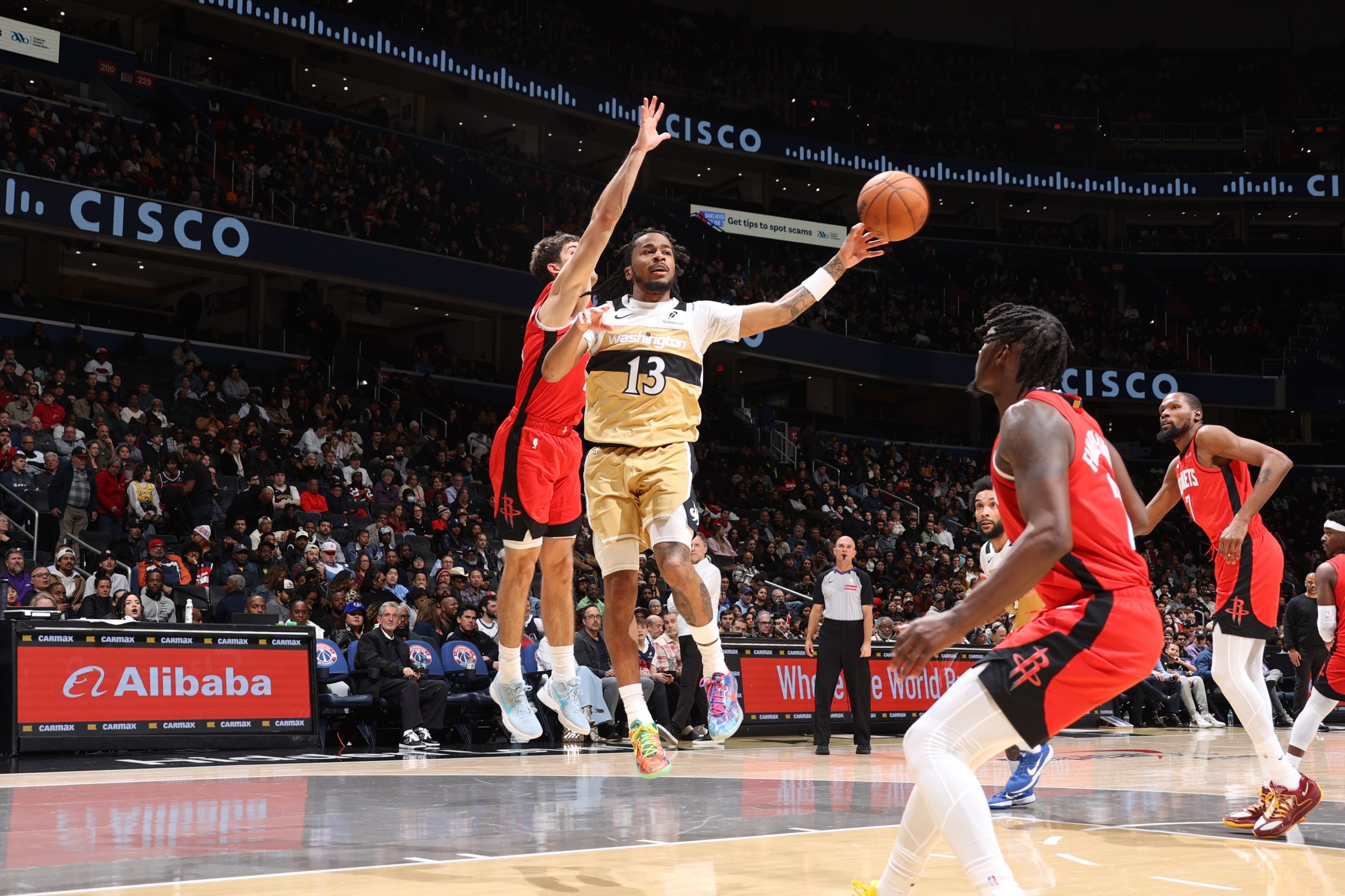 Wizards guard Sharife Cooper with a paint touch and kickout pass during the team’s loss to the Houston Rockets.