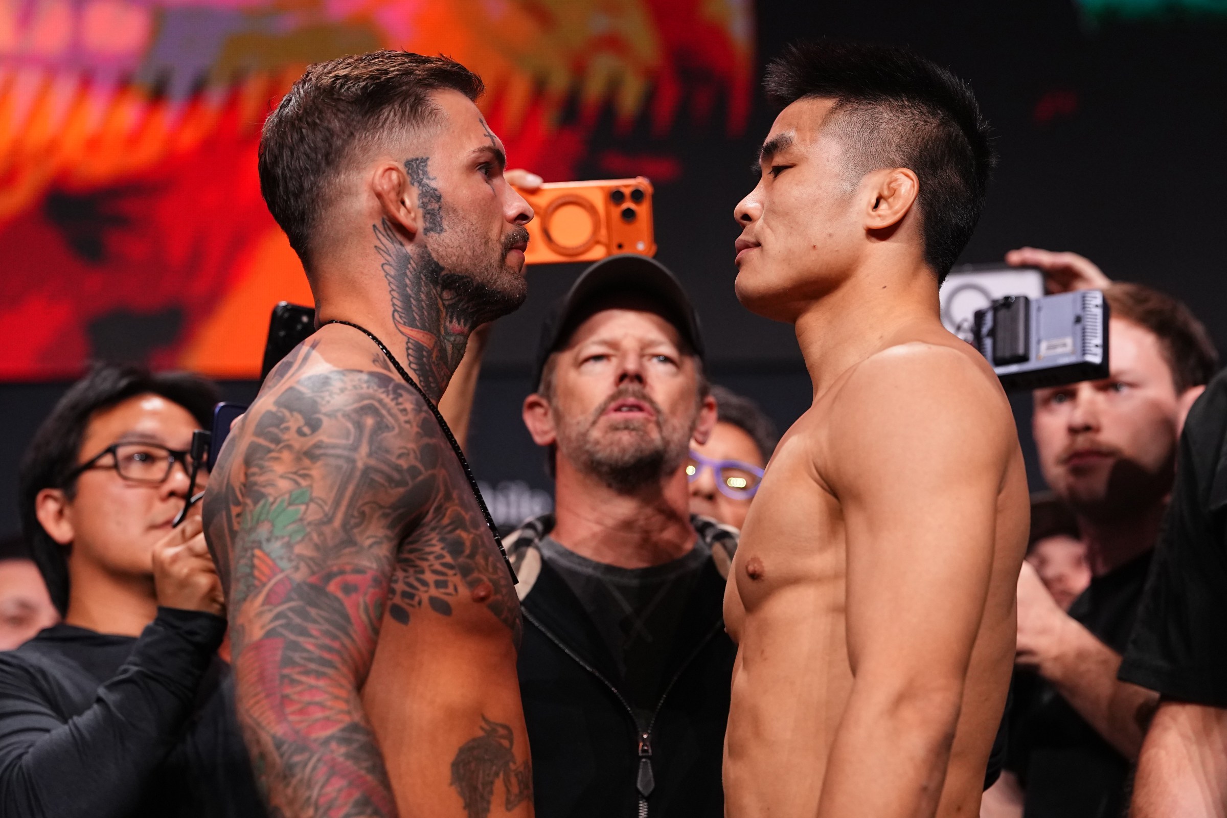 LAS VEGAS, NEVADA - MARCH 06: (L-R) Opponents Cody Garbrandt and Xiao Long of China face off during the UFC 326 ceremonial weigh-in at MGM Grand Garden Arena on March 06, 2026 in Las Vegas, Nevada. (Photo by Chris Unger/Zuffa LLC)