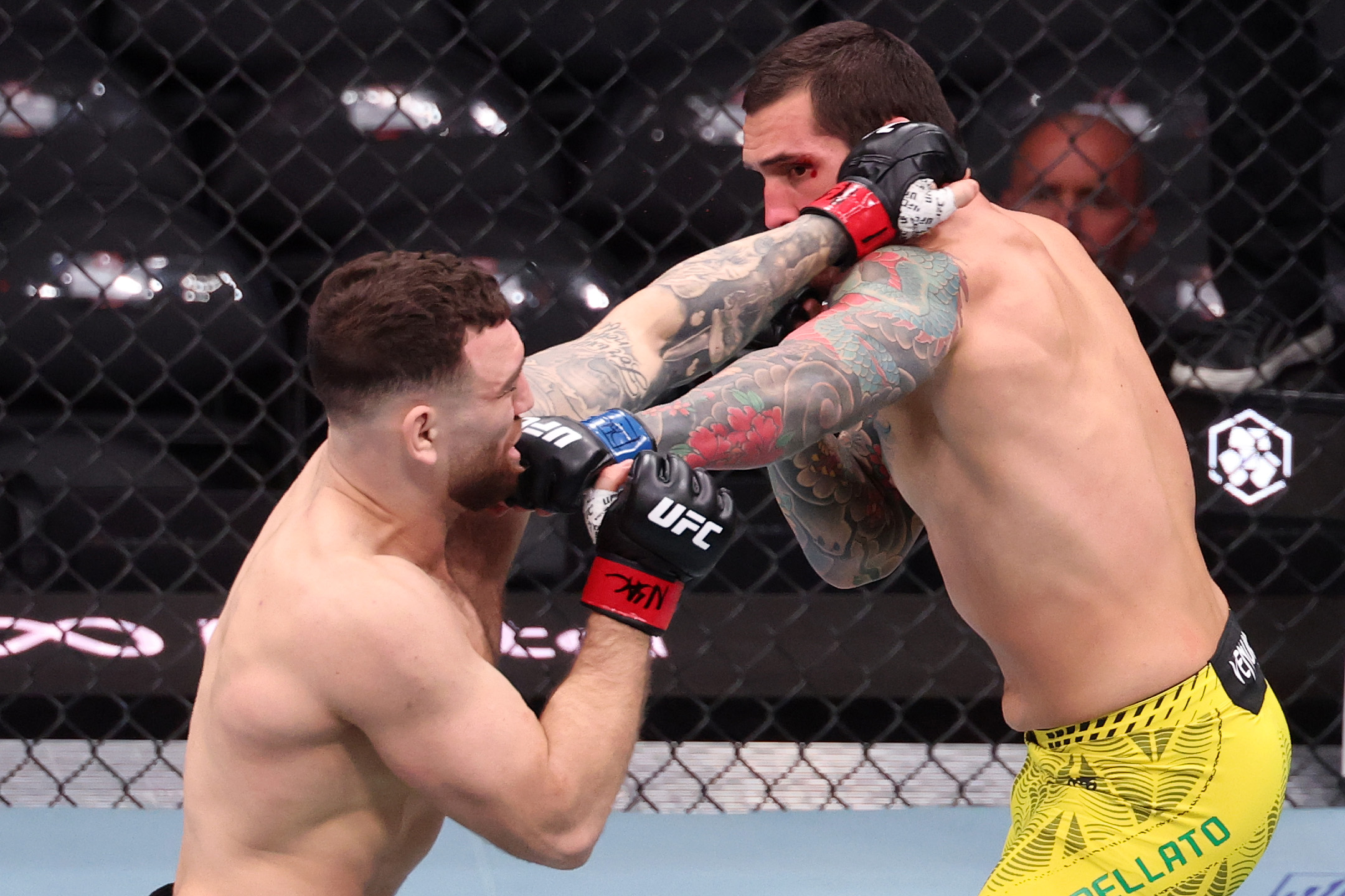 LAS VEGAS, NEVADA - MARCH 07: (L-R) Luke Fernandez trades blows with Rodolfo Bellato of Brazil in a light heavyweight fight during the UFC 326 event at T-Mobile Arena on March 07, 2026 in Las Vegas, Nevada. (Photo by Ed Mulholland/Zuffa LLC)