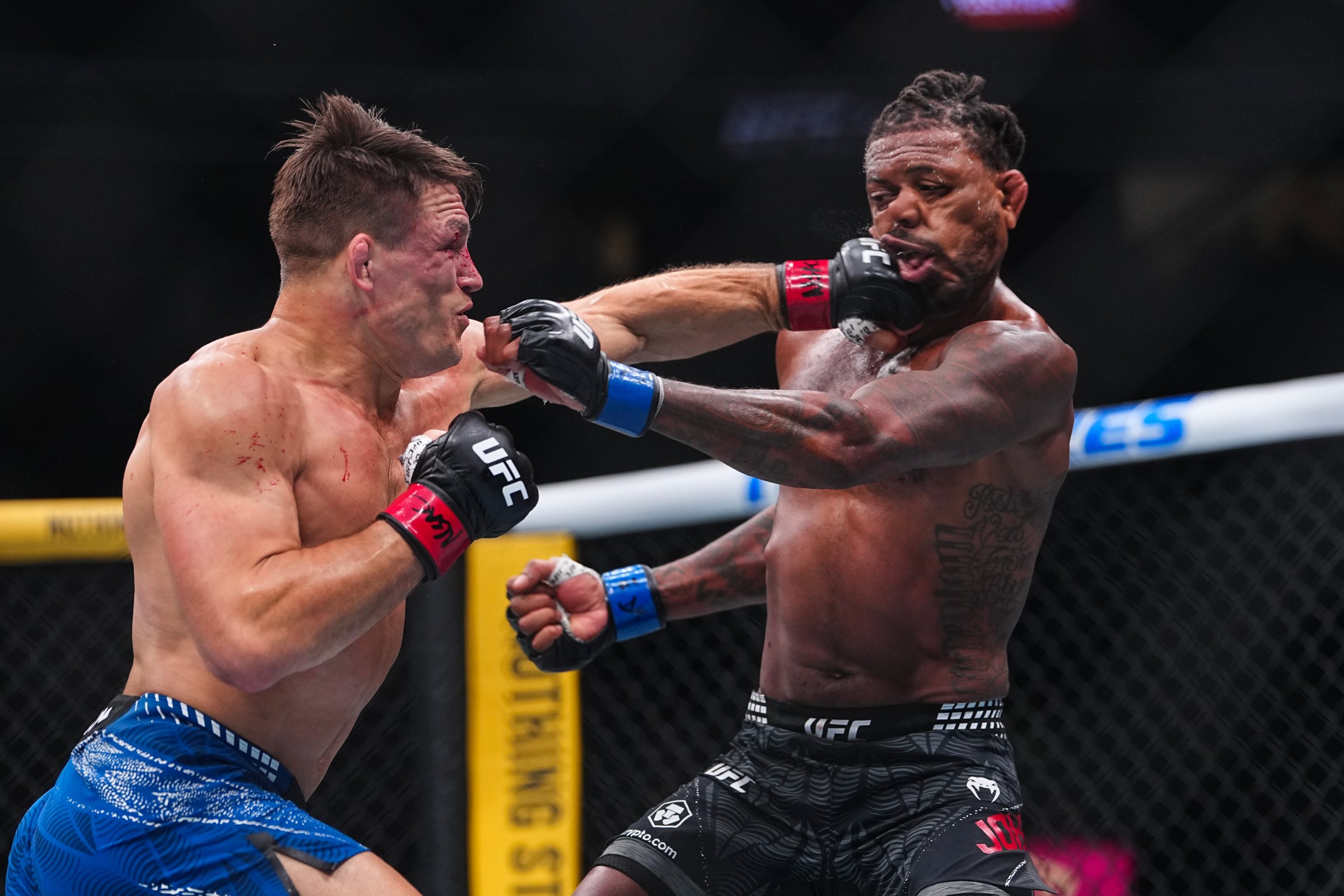 LAS VEGAS, NEVADA - MARCH 07: (L-R) Drew Dober strikes Michael Johnson in a lightweight fight during the UFC 326 event at T-Mobile Arena on March 07, 2026 in Las Vegas, Nevada. (Photo by Chris Unger/Zuffa LLC)