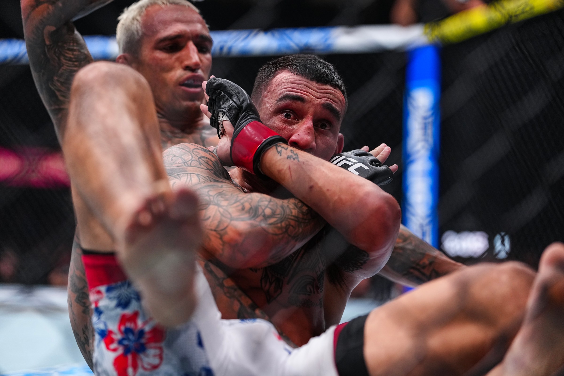 LAS VEGAS, NEVADA - MARCH 07: Max Holloway defends against Charles Oliveira of Brazil in the BMF Championship fight during the UFC 326 event at T-Mobile Arena on March 07, 2026 in Las Vegas, Nevada. (Photo by Chris Unger/Zuffa LLC)