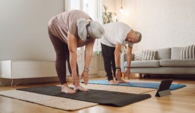 senior couple touch toes on yoga mats